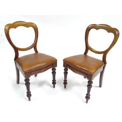 341 - A pair of 19thC mahogany balloon back chairs, the inset seats upholstered with brown leather. Each a... 