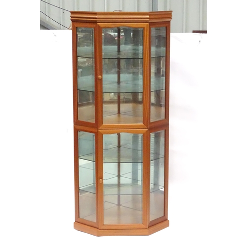 344 - A modern glazed corner display unit by James H Sutcliffe & Son, of teak construction with glass shel... 