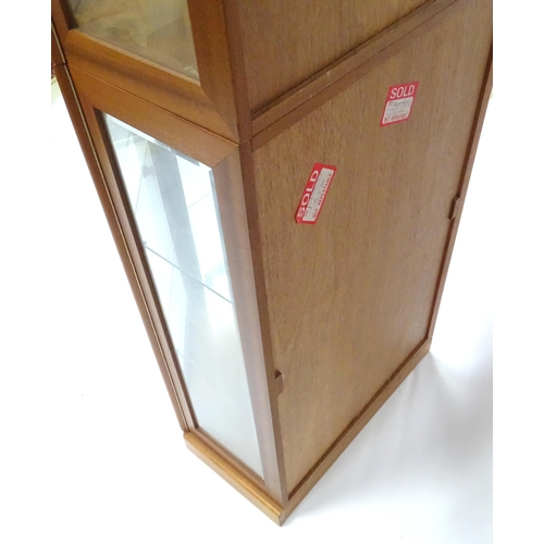 344 - A modern glazed corner display unit by James H Sutcliffe & Son, of teak construction with glass shel... 