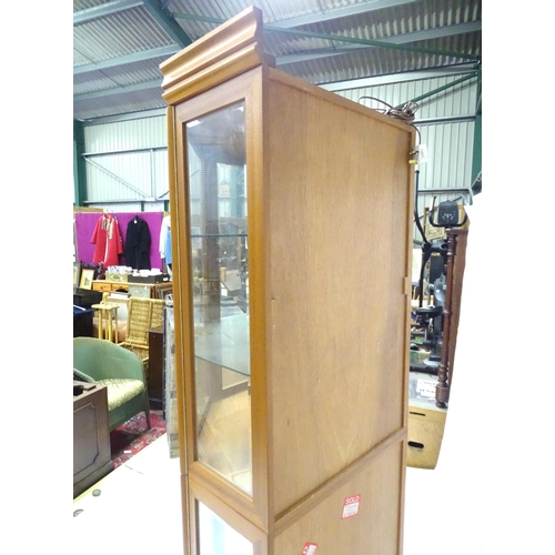 344 - A modern glazed corner display unit by James H Sutcliffe & Son, of teak construction with glass shel... 