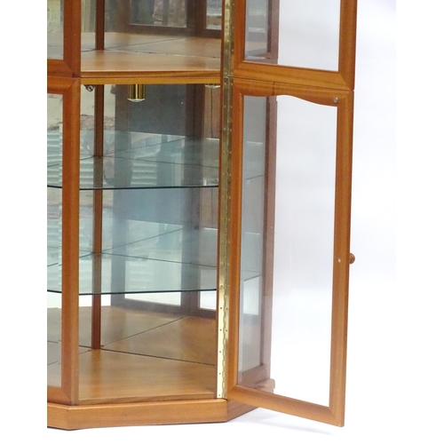 344 - A modern glazed corner display unit by James H Sutcliffe & Son, of teak construction with glass shel... 