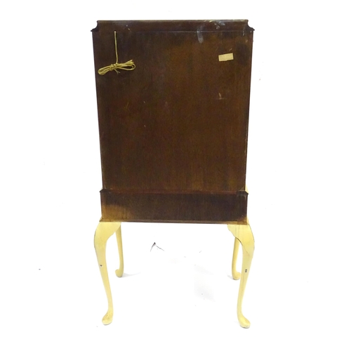 347 - A mid 20thC cocktail cabinet, the exterior with clouded yellow finish and oriental mounts. The upper... 