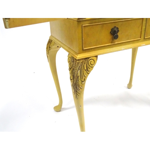 347 - A mid 20thC cocktail cabinet, the exterior with clouded yellow finish and oriental mounts. The upper... 