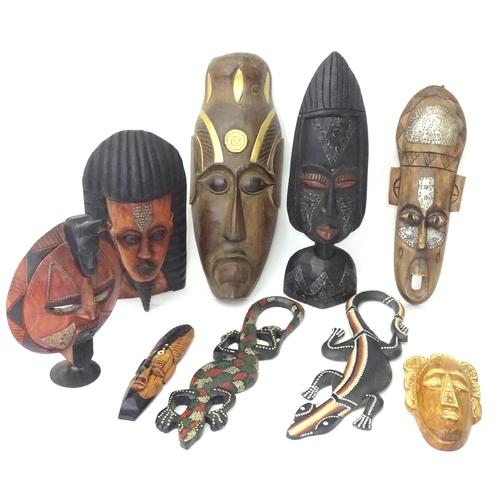 349 - A quantity of assorted carved wooden masks with incised and applied detail. Together with carved mod... 