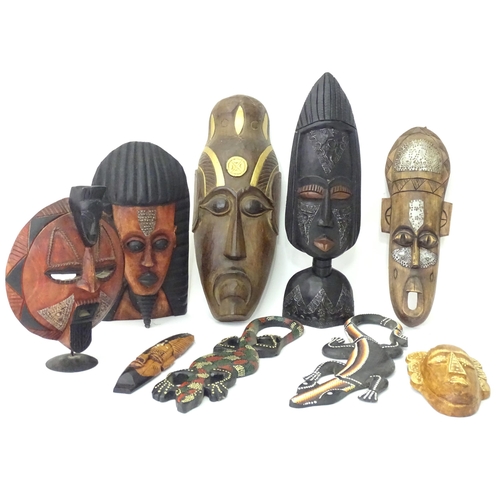 349 - A quantity of assorted carved wooden masks with incised and applied detail. Together with carved mod... 