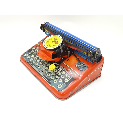 357 - Toy: A Mettoy Junior tinplate toy typewriter with original box.