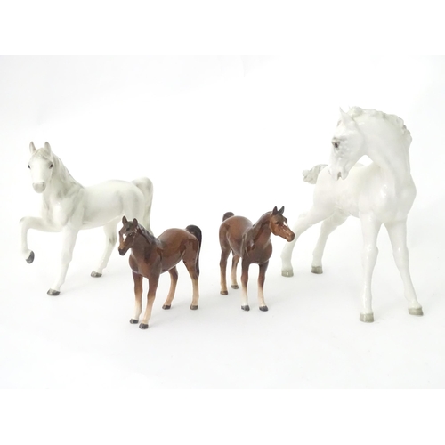 362 - Four assorted ceramic models of horses. Largest approx. 8 1/2