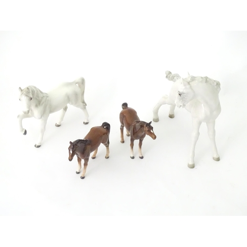 362 - Four assorted ceramic models of horses. Largest approx. 8 1/2