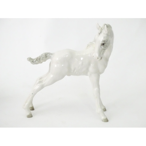 362 - Four assorted ceramic models of horses. Largest approx. 8 1/2