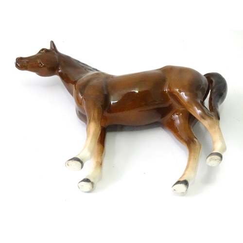 362 - Four assorted ceramic models of horses. Largest approx. 8 1/2