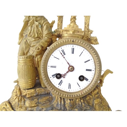 170 - A late 19thC gilt clock with figural decoration of a cooper / brewer with barrel and press. With ena... 