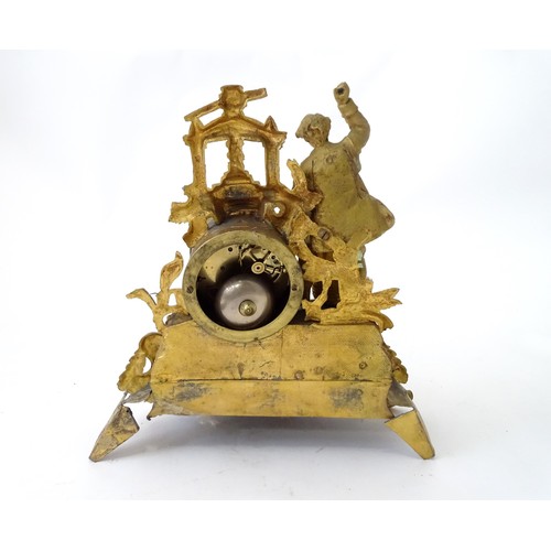 170 - A late 19thC gilt clock with figural decoration of a cooper / brewer with barrel and press. With ena... 