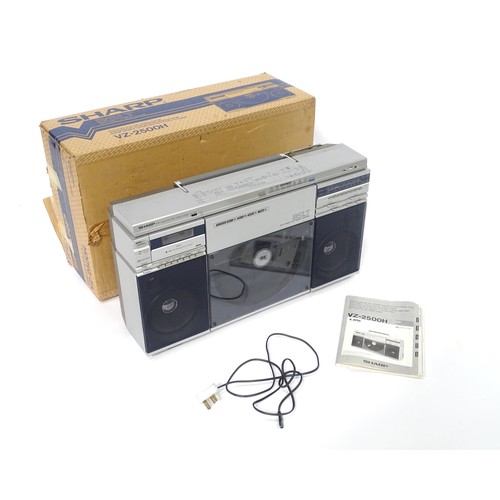 203 - A late 20thC boxed Sharp VZ-2500 portable stereo system, with turntable, tape deck, radio tuner, 4 x... 