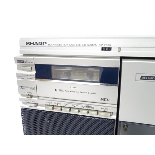 203 - A late 20thC boxed Sharp VZ-2500 portable stereo system, with turntable, tape deck, radio tuner, 4 x... 