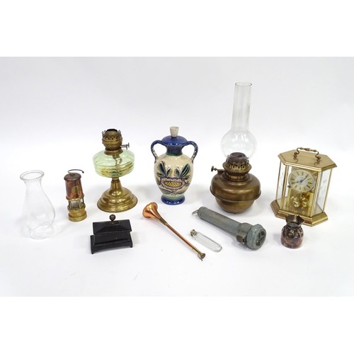 241 - A quantity of assorted items to include clock, oil lamp sections, torch, pot and cover, exceptionall... 