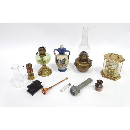 241 - A quantity of assorted items to include clock, oil lamp sections, torch, pot and cover, exceptionall... 