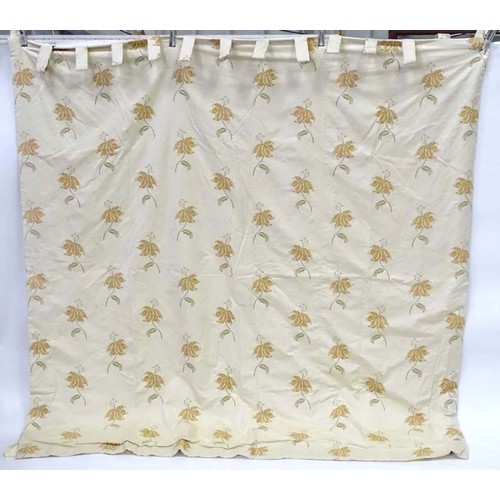 1090 - A pair of tab top curtains decorated with floral motifs, each approx 84