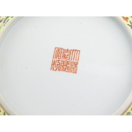 12 - A Chinese famille rose plate / dish decorated with floral and foliate decoration, the reverse with a... 