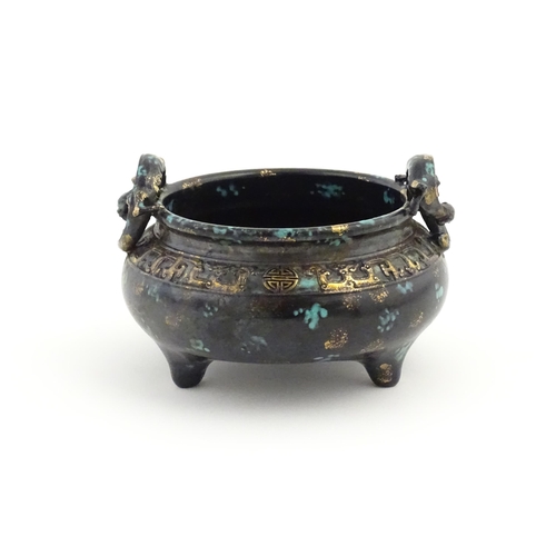 27 - A Chinese censer with twin handles of stylised salamander form with relief banded decoration. Charac... 