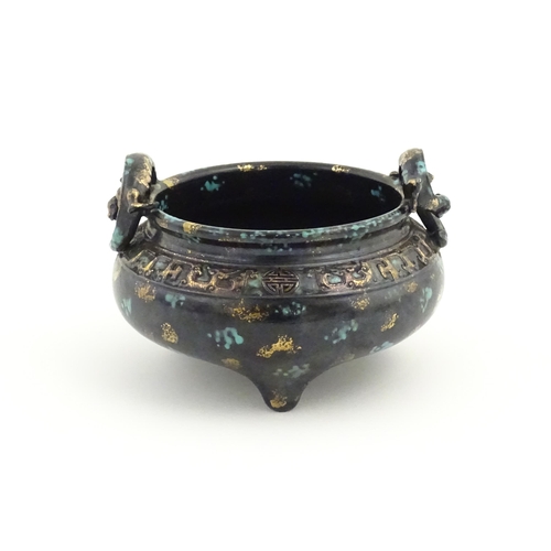 27 - A Chinese censer with twin handles of stylised salamander form with relief banded decoration. Charac... 