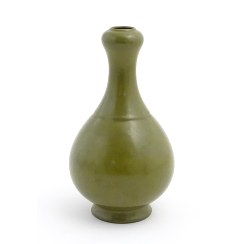 30 - A Chinese bottle vase with tea coloured glaze. Character marks under. Approx. 11