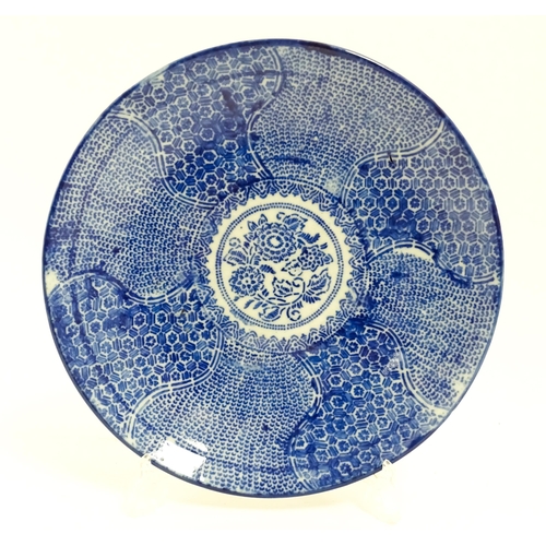 37 - A Japanese blue and white plate with central floral motif bordered by bands of patterned detail and ... 