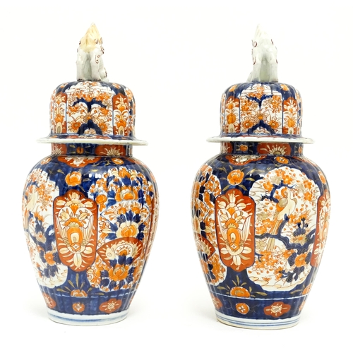 68 - A pair of Japanese lobed lidded vases decorated with birds, fans, flowers and foliage in the Imari p... 