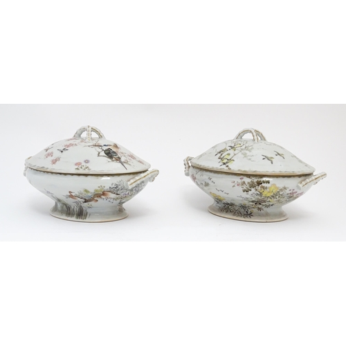 71 - A pair of Japanese tureens / lidded serving dishes with hand painted decorating various flowers and ... 