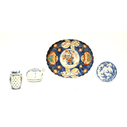 72 - Four assorted Oriental items comprising a Japanese dish of oval form decorated in the Imari palette ... 