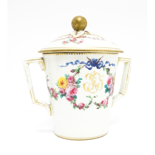 88 - A Sevres twin handled pot and cover decorated with floral garlands and bow detail, with gilt monogra... 