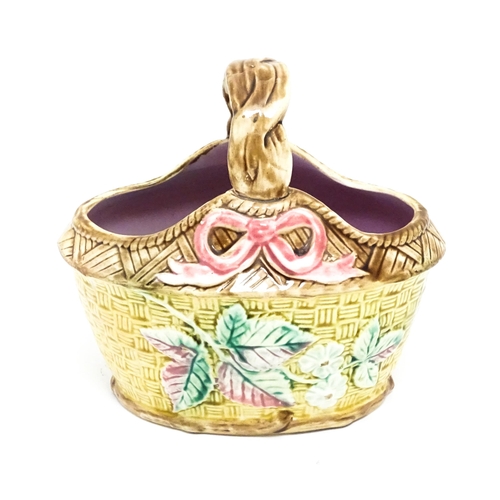 93 - A Victorian majolica basket with pink glazed interior, the woven style exterior with floral, foliate... 