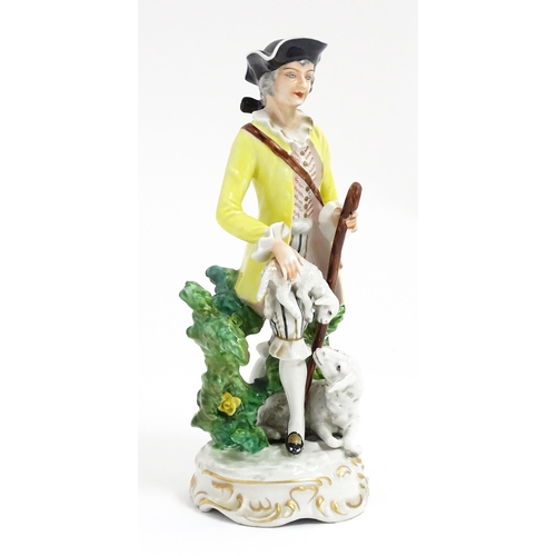 194 - A Continental figure modelled as a shepherd boy with bocage, crook and lambs. Approx. 9 3/4