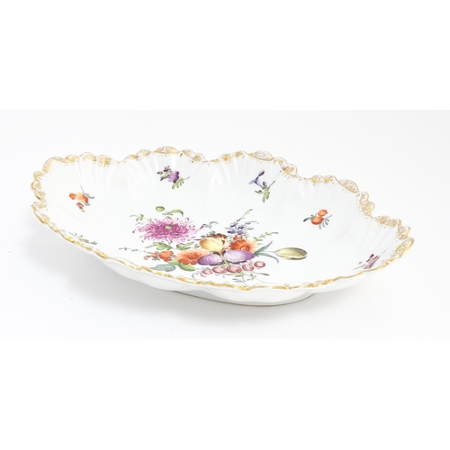 210 - A Dresden dish of shaped form with hand painted decoration depicting a floral spray further bordered... 