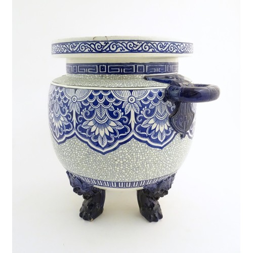 233 - A large Victorian Minton blue and white jardiniere / planter with twin handles standing on four feet... 