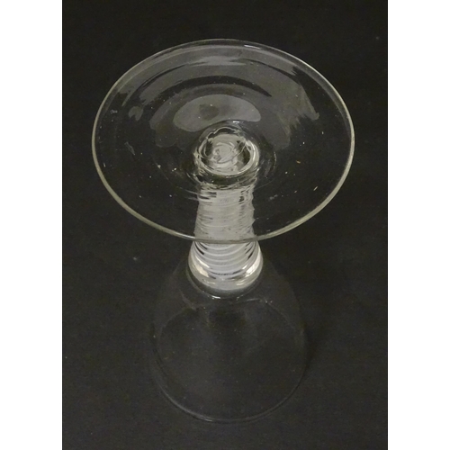 308 - An 18thC funnel bowl wine glass with opaque twist stem. Approx. 4 3/4