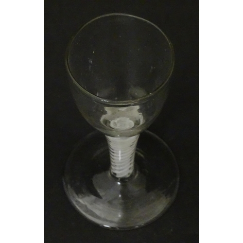 308 - An 18thC funnel bowl wine glass with opaque twist stem. Approx. 4 3/4