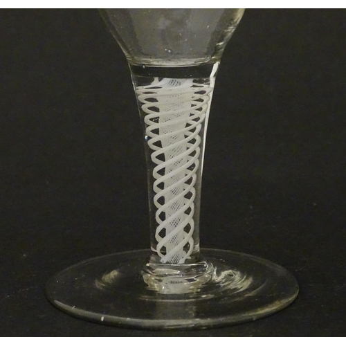 308 - An 18thC funnel bowl wine glass with opaque twist stem. Approx. 4 3/4