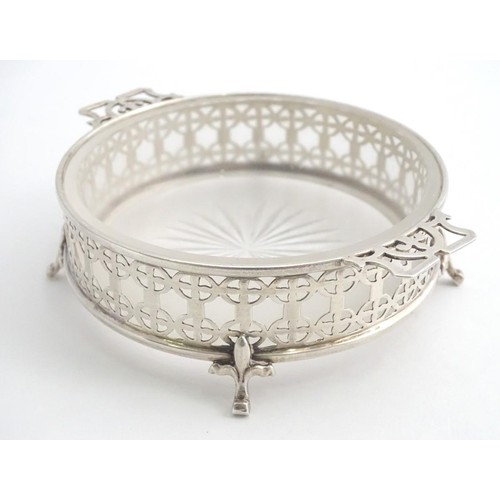 375 - A silver butter / preserve dish with twin handles and glass liner, The frame with geometric openwork... 