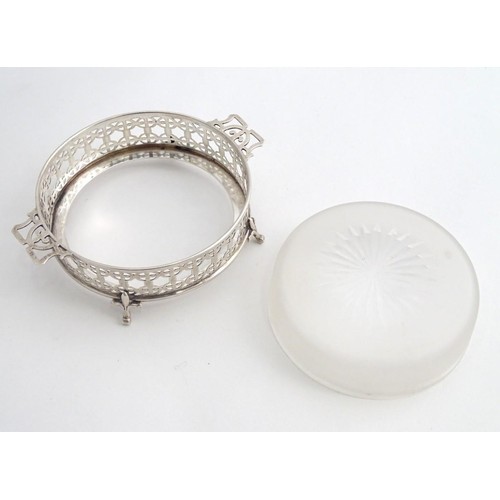 375 - A silver butter / preserve dish with twin handles and glass liner, The frame with geometric openwork... 