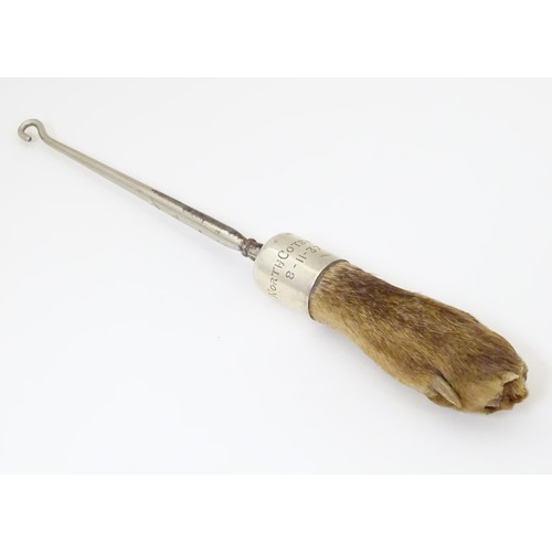 580 - Taxidermy : A button hook, the handle formed as an otter paw with silver collar engraved North Cotsw... 