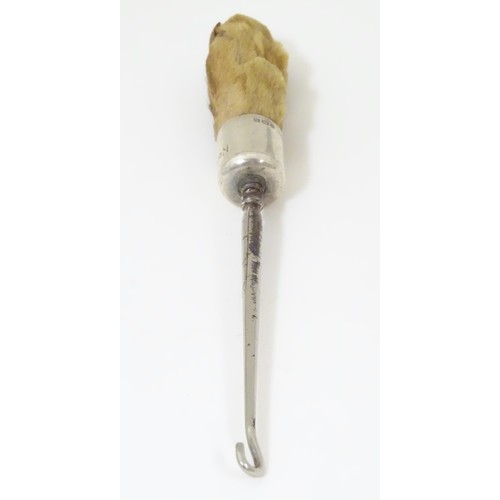 580 - Taxidermy : A button hook, the handle formed as an otter paw with silver collar engraved North Cotsw... 