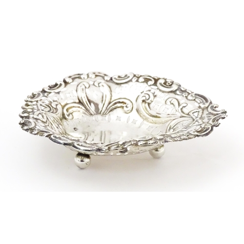 335 - A Victorian silver bon bon dish with pierced decoration and raised on ball feet, hallmarked Chester ... 