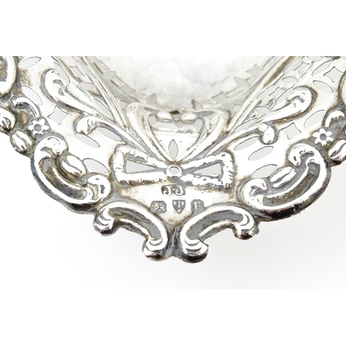 335 - A Victorian silver bon bon dish with pierced decoration and raised on ball feet, hallmarked Chester ... 