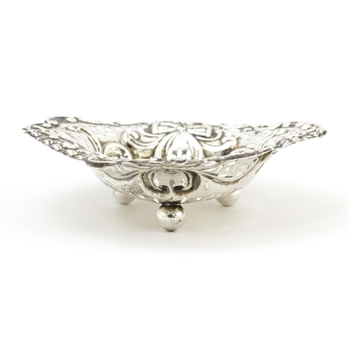 335 - A Victorian silver bon bon dish with pierced decoration and raised on ball feet, hallmarked Chester ... 