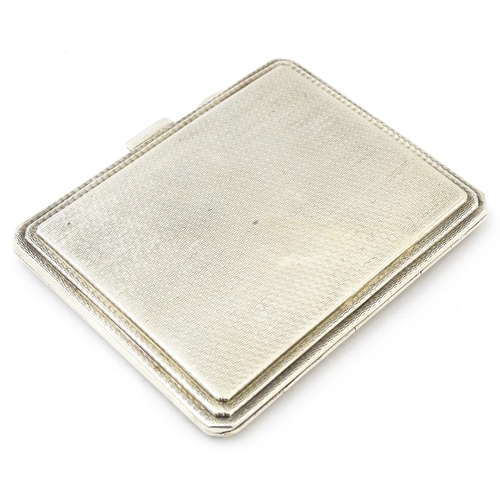 340 - An Art Deco silver compact of rectangular form with engine turned decoration hallmarked Birmingham 1... 