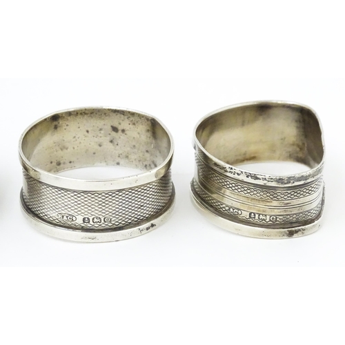 364 - Four various 20thC silver napkin rings to include examples with engine turned decoration etc. (4)