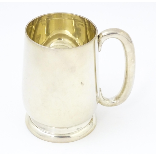 385 - A silver christening mug with loop handle, hallmarked Birmingham 1937, maker Joseph Gloster Ltd. App... 