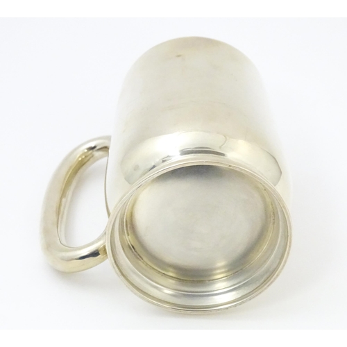 385 - A silver christening mug with loop handle, hallmarked Birmingham 1937, maker Joseph Gloster Ltd. App... 