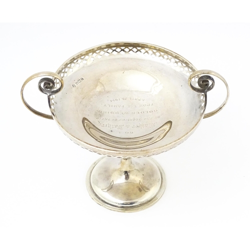 388 - A silver tazza with pierced decoration and scrolling twin handles, hallmarked Sheffield 1911, maker ... 