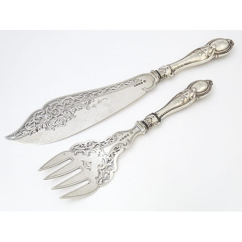 390 - A pair of Victorian silver fish servers hallmarked Birmingham 1865, maker Thomas Prime & Son. Larges... 